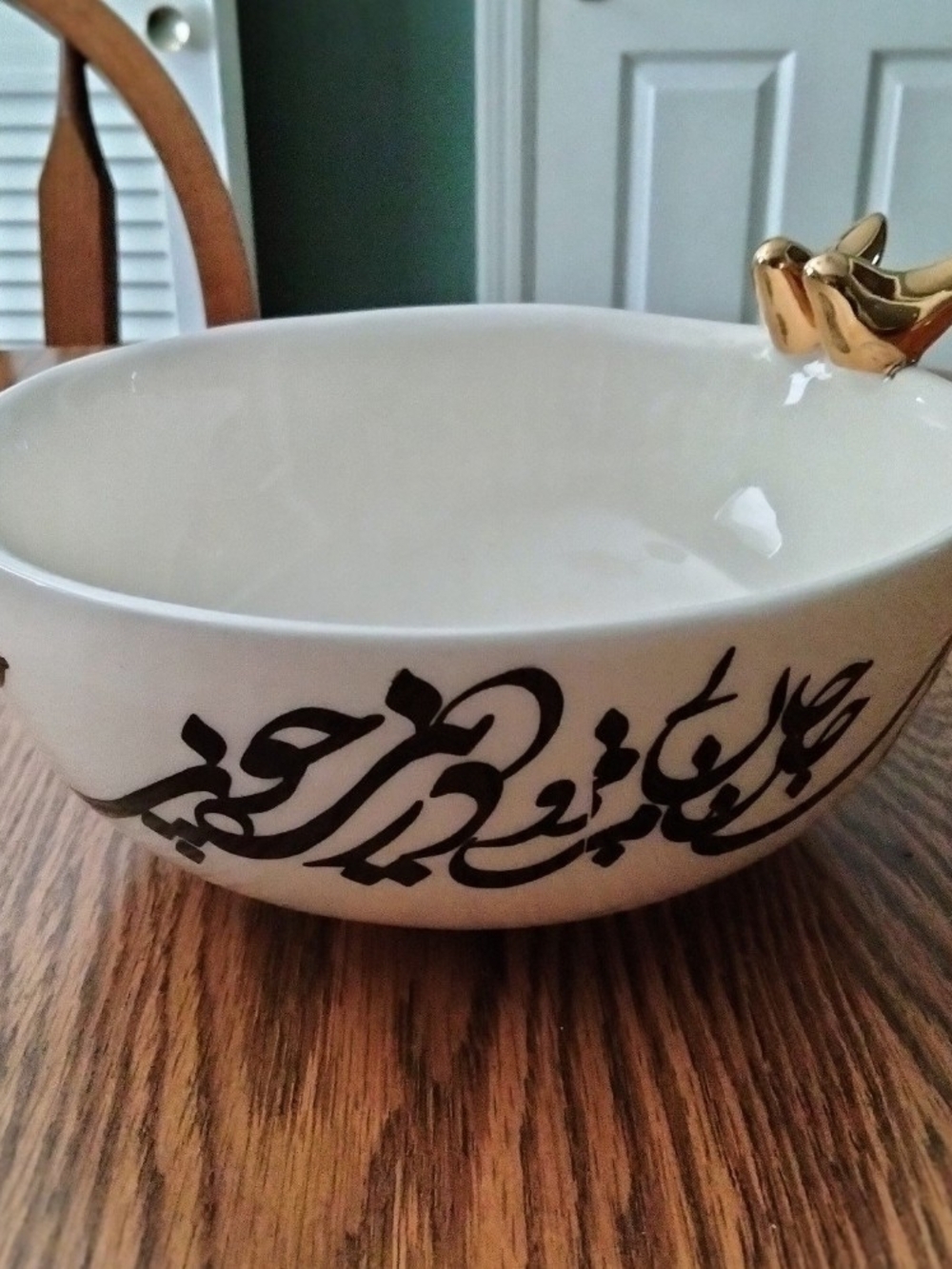 White Ceramic Decorative Bowl with Black Calligraphy and Gold Bird Accent